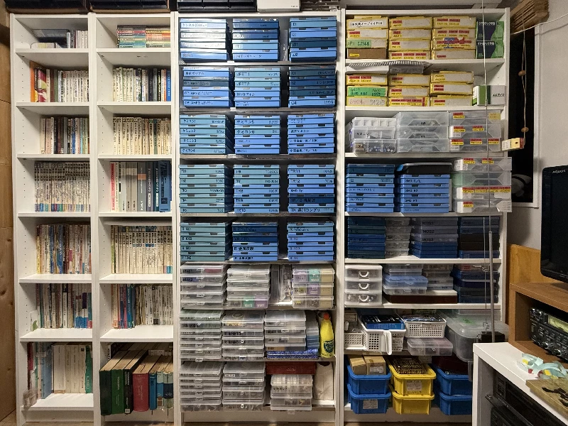 Shelves filled with vintage transistor parts cases and Japanese semiconductor databooks