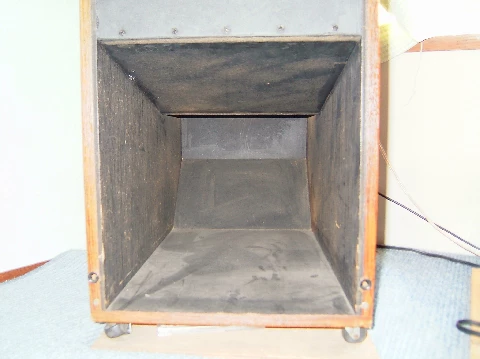 Mouth of the back-loaded horn where bass emerges through a folded sound path (Photo 1-41)