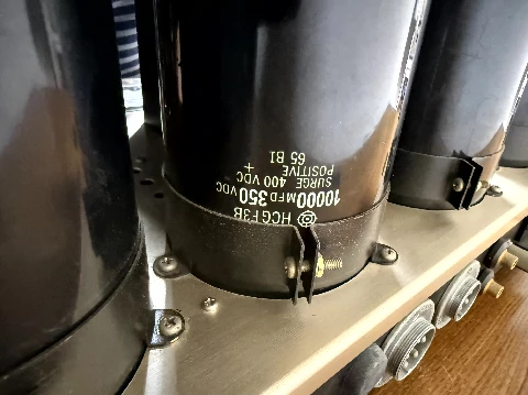 Industrial-grade electrolytic capacitors, heavy and secured with metal bands (Photo 1-17)