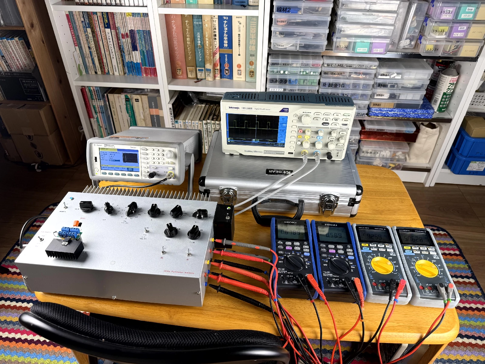 Custom-built SPICE parameter analyzer with four simultaneous multimeter channels monitoring Ic, Ib, Vce, and Vbe